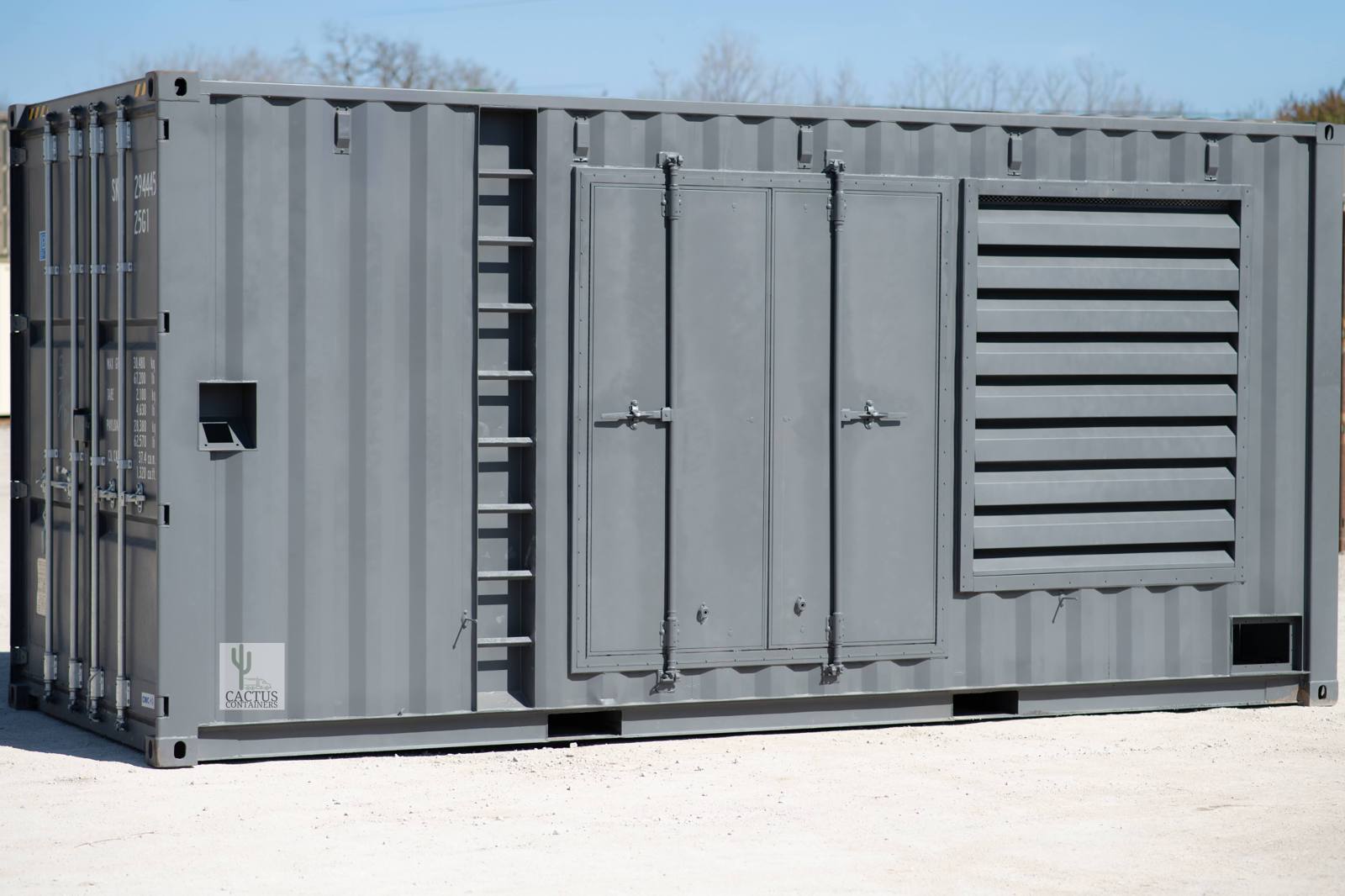 A grey shipping container modified into a generator enclosure, with louvred vents and service access doors